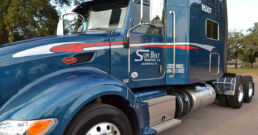 Sunbelt Transport flatbed truck parked in the yard.