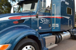 Sunbelt Transport flatbed truck parked in the yard.