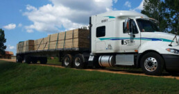 Flatbed truck transporting pre-loaded with building materials.